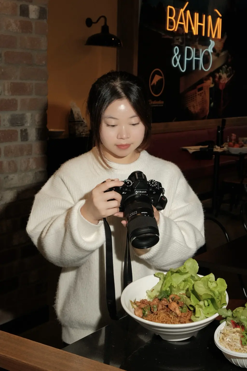 Hailey Nguyen checking her camera on set